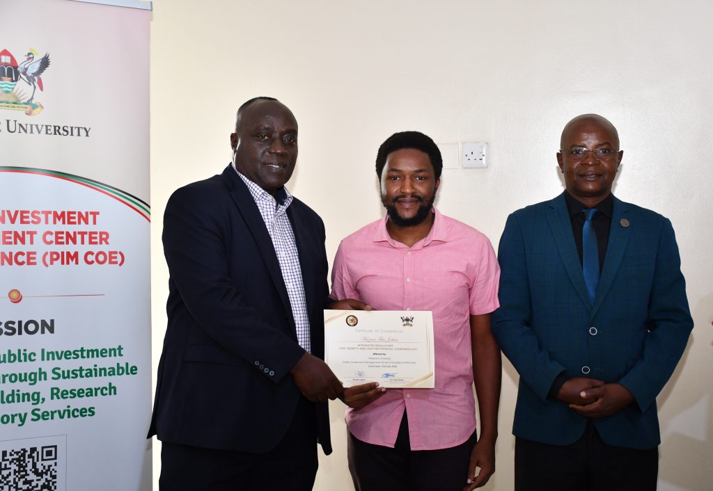 Commissioner Henry Mwanja (Left), Trainee (center), and Prof Bbaale (Right)